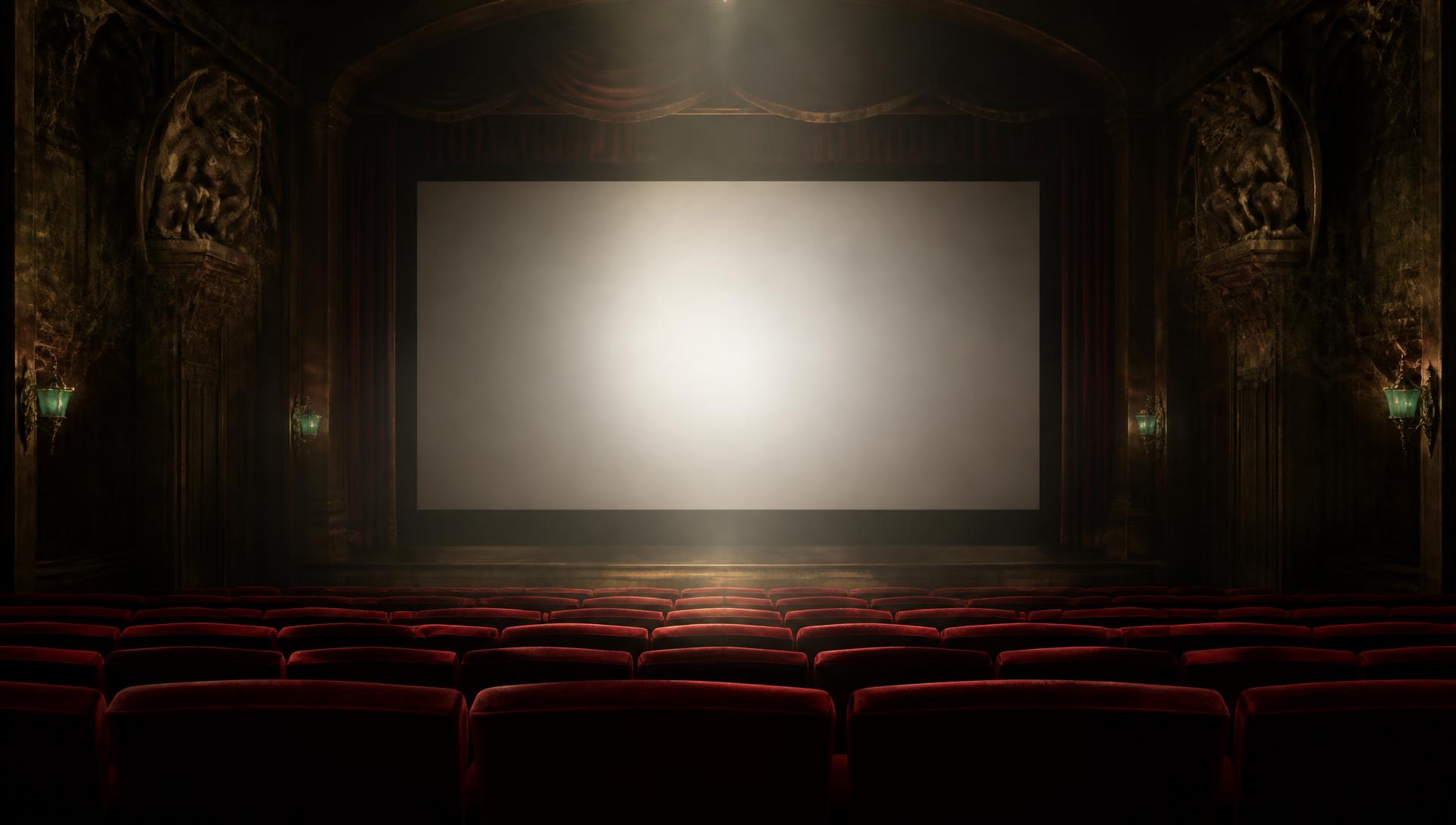 Planet Dread Cinema — a straight-on view of a grand glowing silver screen framed by crimson velvet curtains, gargoyle reliefs and green glass sconces, rows of empty red seats sloping toward the screen.